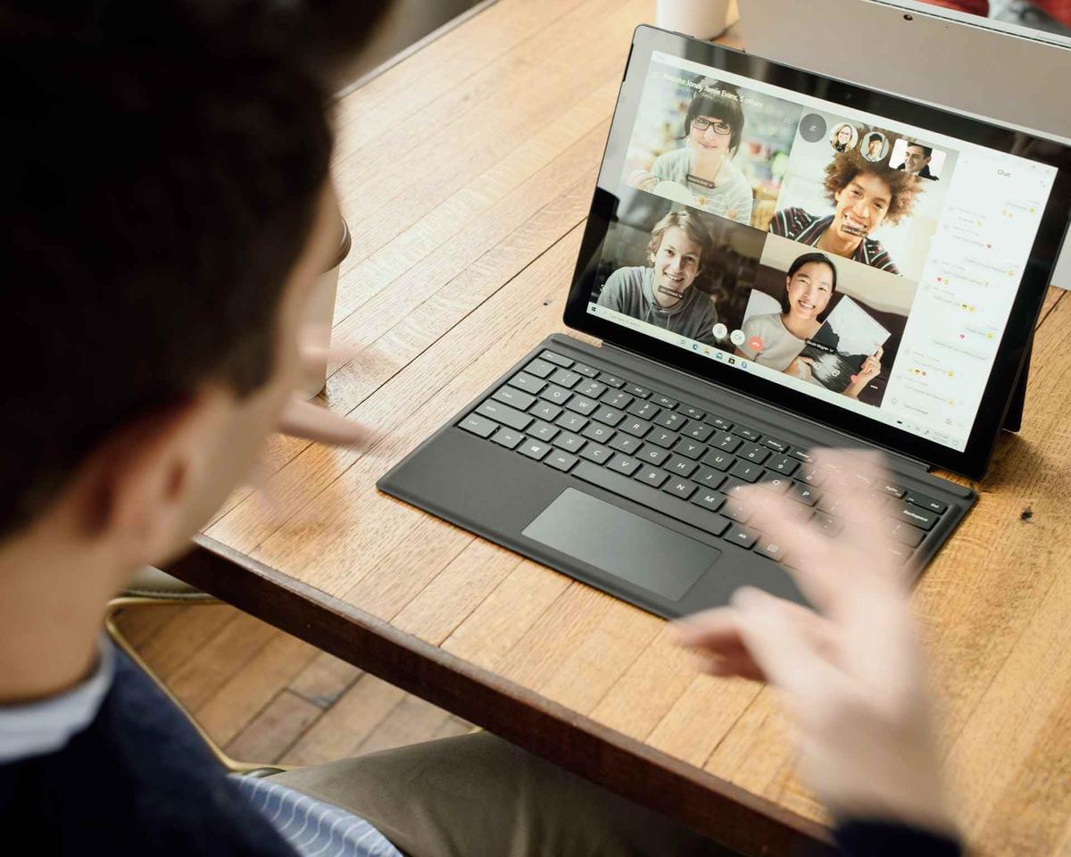 Person having a virtual meeting through a conferencing tool on their laptop