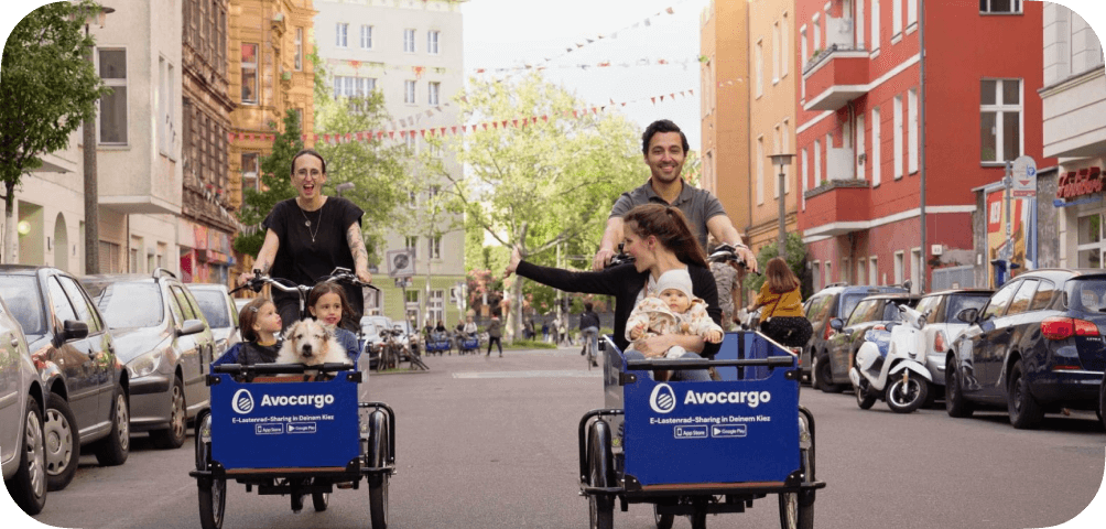 Two people riding next to each other on Avocargo bikes