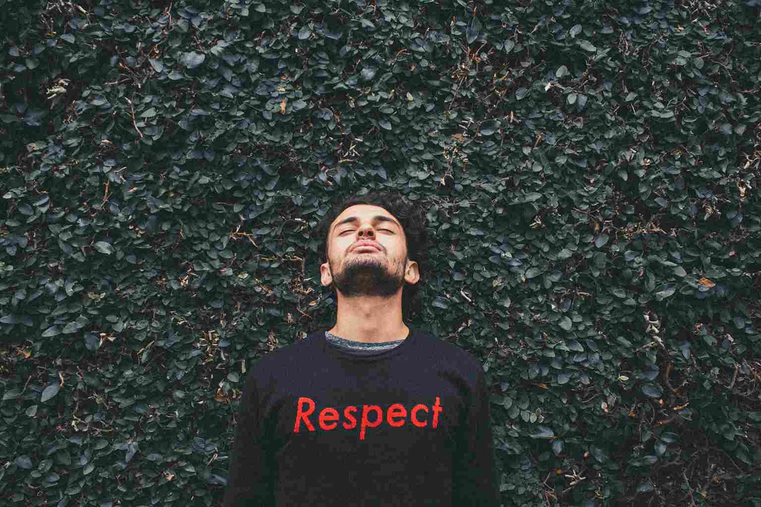 Person standing in front of a bush, t-shirt saying RESPECT, the thing employees demand or they resort to quietly quitting