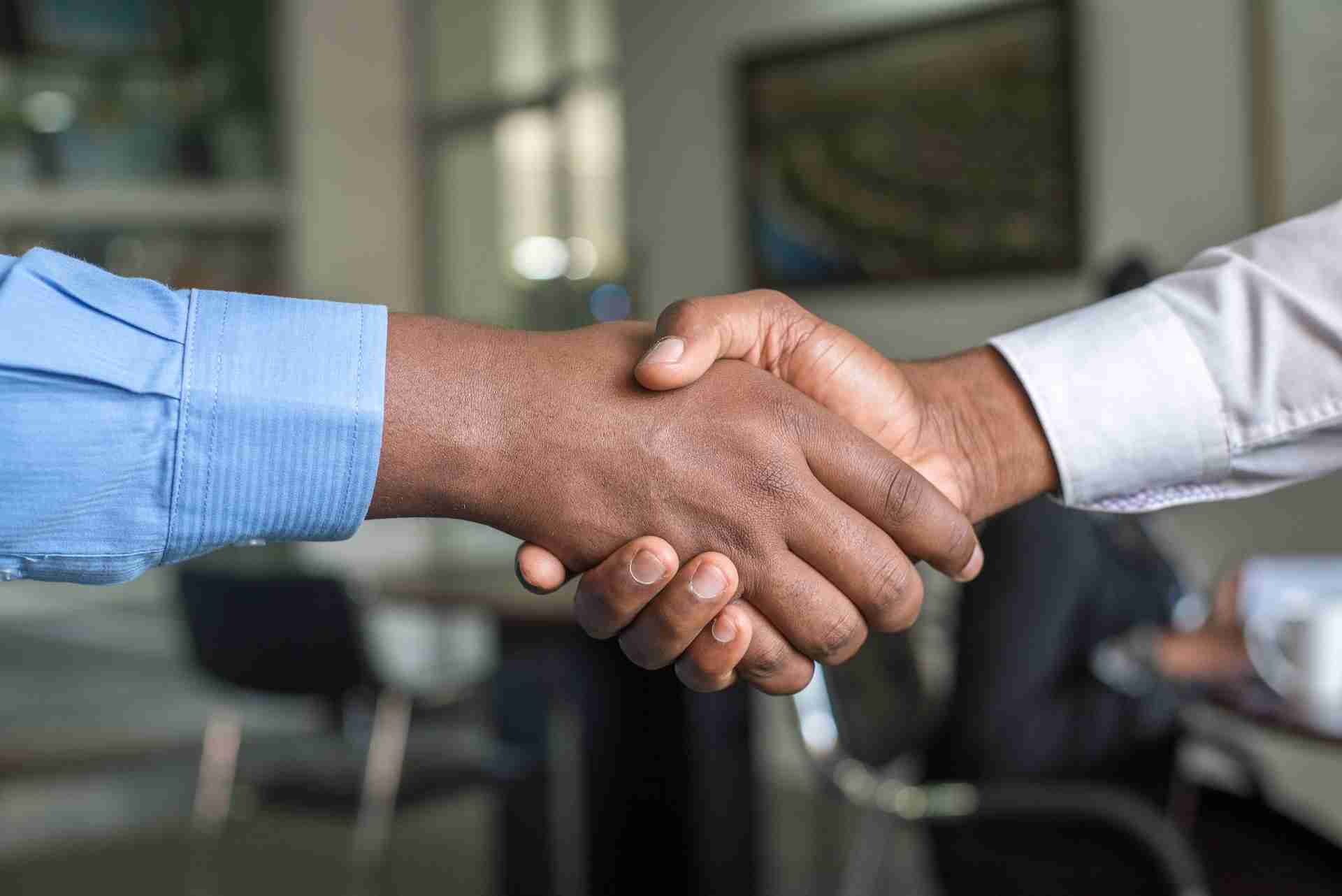 Two people shaking hands as confirmation to hire a project manager